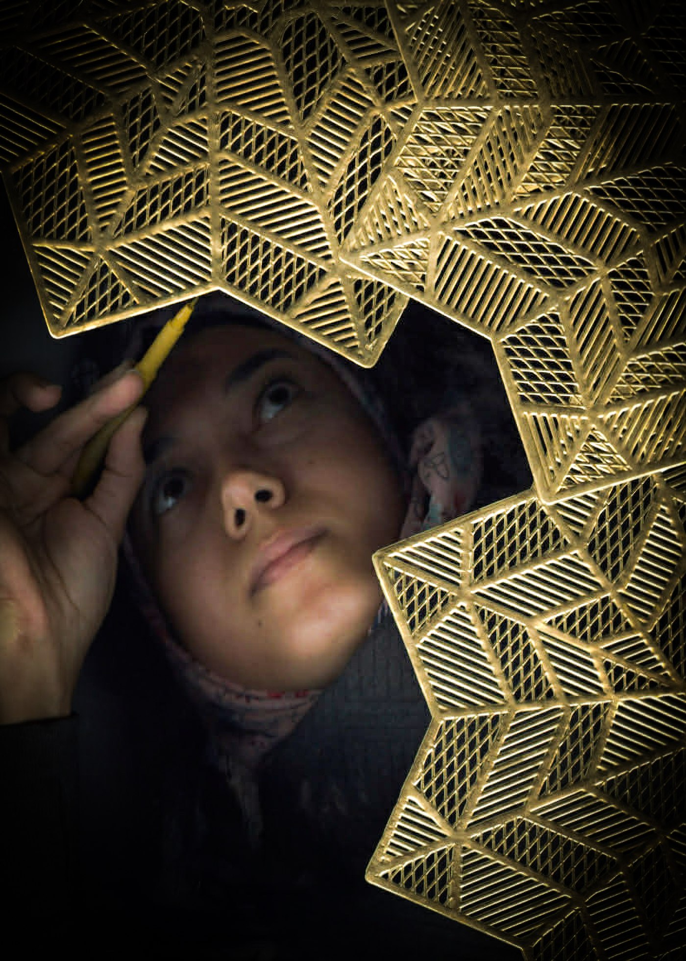 Amal Abdalla portrait — working beneath a gold Islamic geometric pattern
