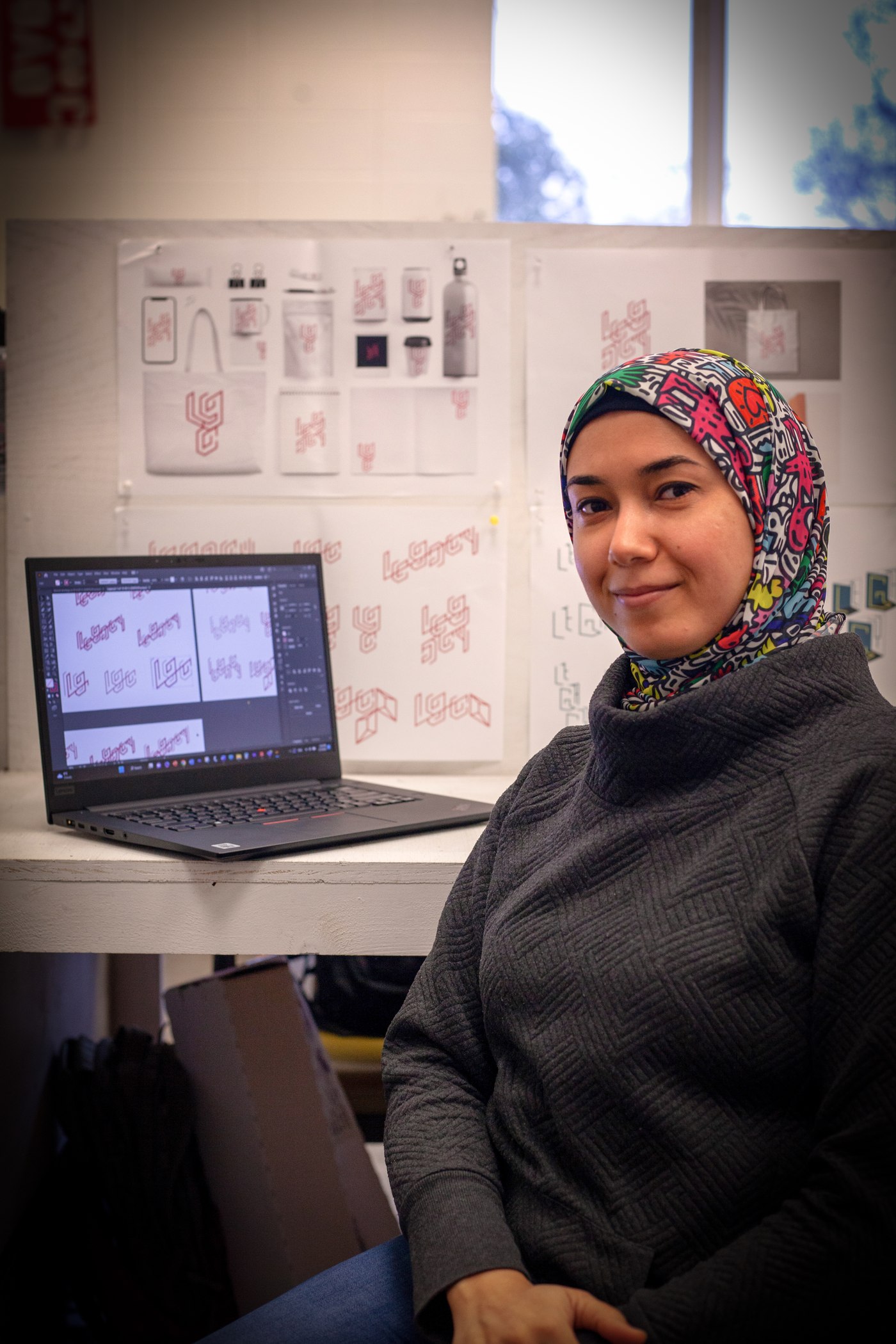 Amal Abdalla in her studio, working on the LEGACY conference branding