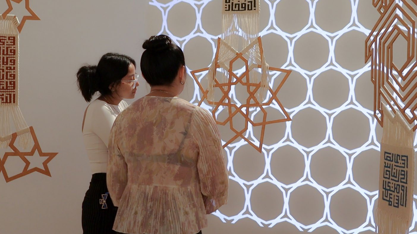 Two visitors discussing the work