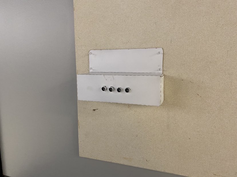Custom white sensor enclosure on gallery wall