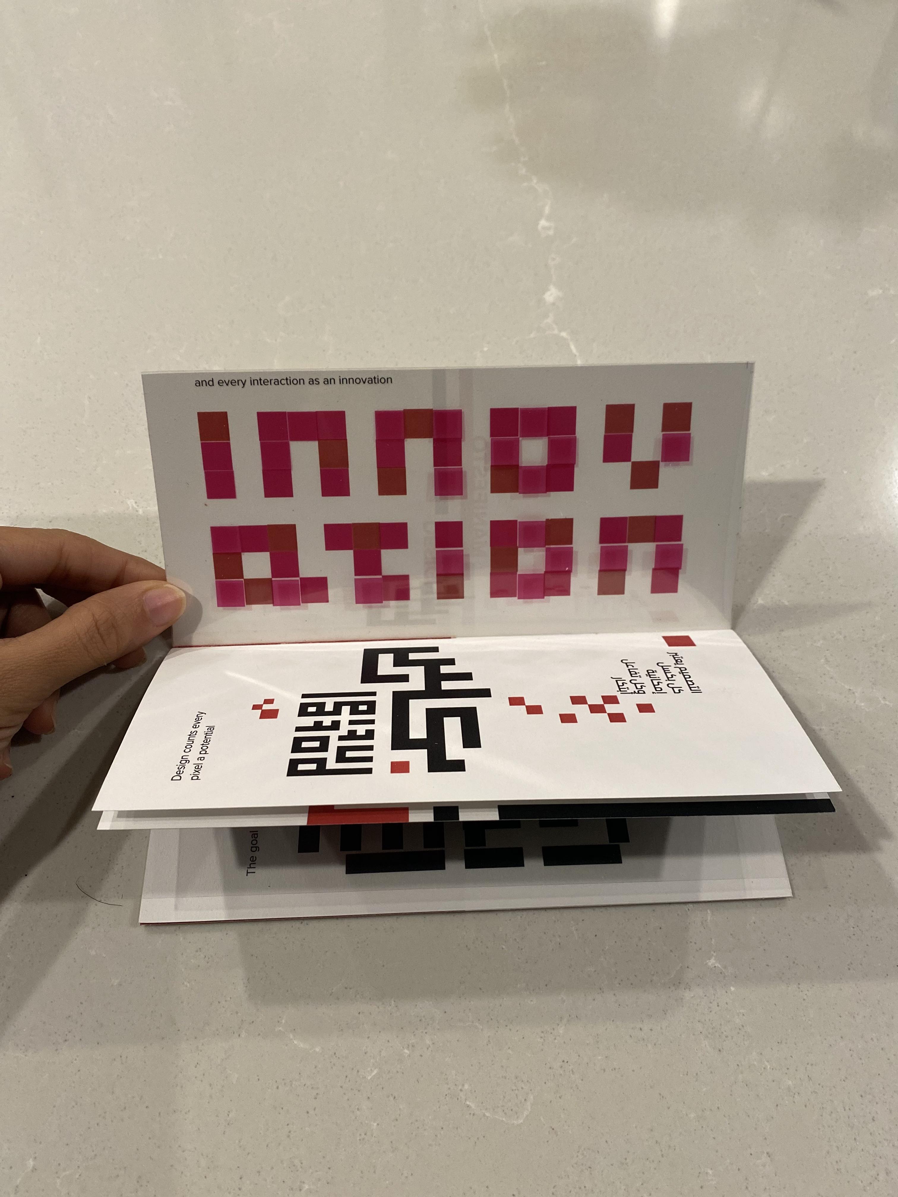 Printed Harmony zine open showing INNOVATION spread