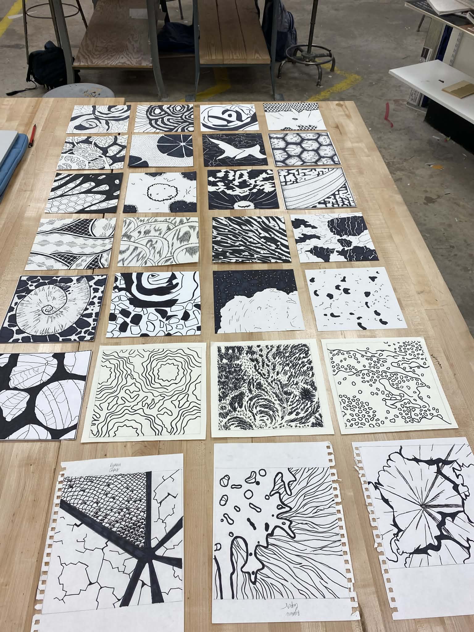Student work laid out for critique — angled view