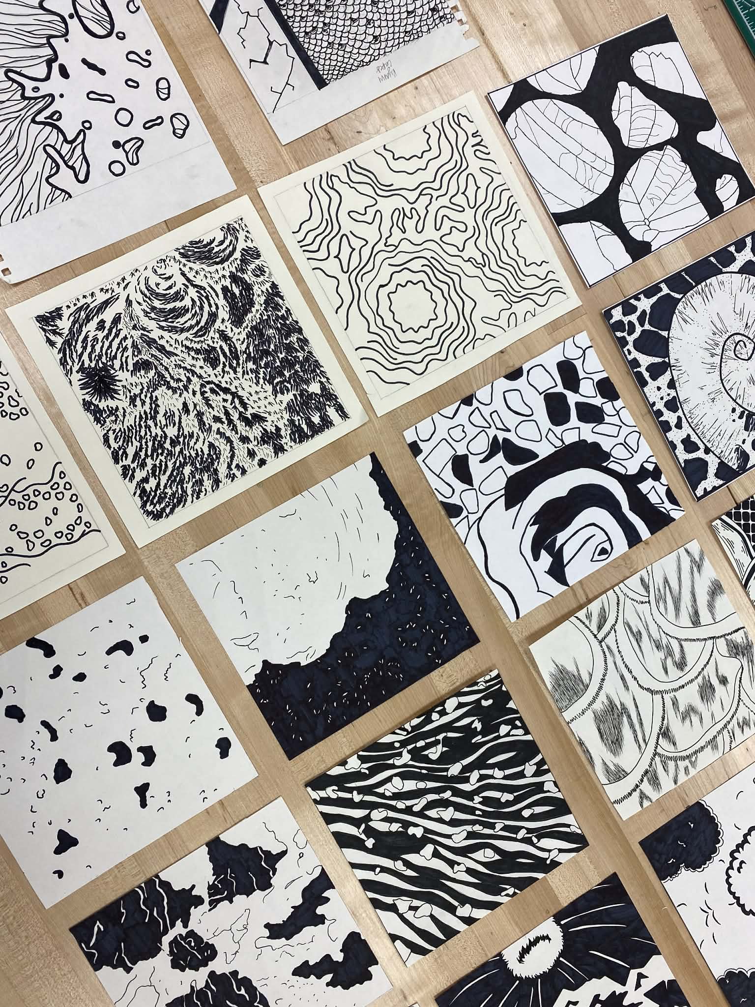 Student work laid out for critique — close view